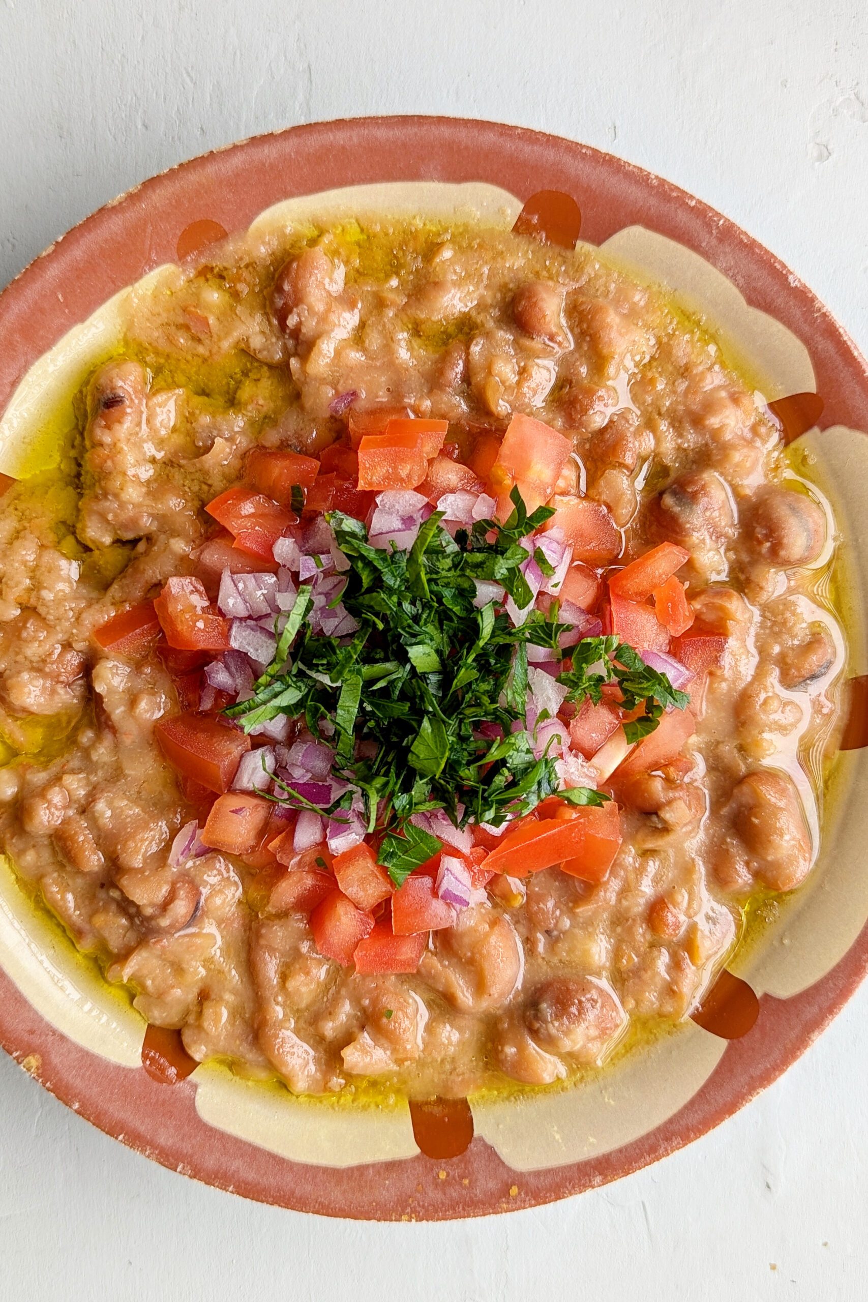 Traditional Gaza Ful โ Gaza's mashed fava-bean breakfast โ garlicky, lemony, drowned in good olive oil and shared from one plate.