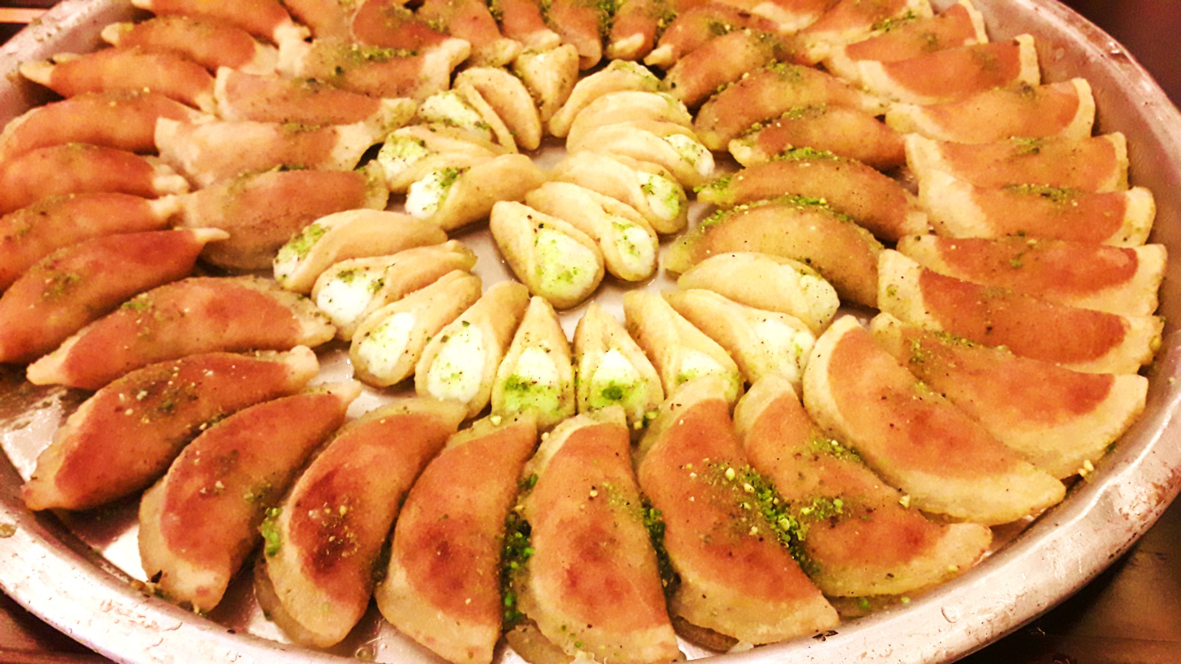 Palestinian Qatayef โ Palestine's cherished Ramadan sweet โ crisp fried pancakes filled with cinnamon walnuts, dipped in syrup.